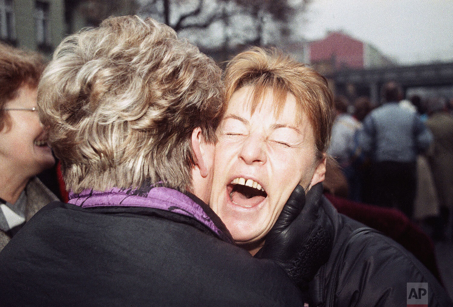  East German Rosemarie Doln is overwhelmed with emotion as she is welcomed by an unidentified relative at the opening of latest wall passage at Wollankstrasse in West Berlin's district of Wedding, Nov. 13, 1989 in Berlin. (AP Photo/John Gaps III) 