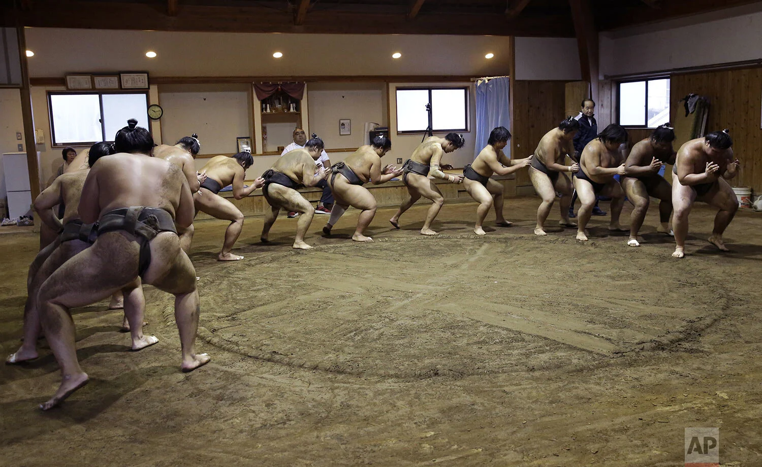 Sumo wrestlers perform an exercise during training at the Musashigawa Sumo Stable in Beppu, western Japan, riday, Oct. 18, 2019. (AP Photo/Aaron Favila)