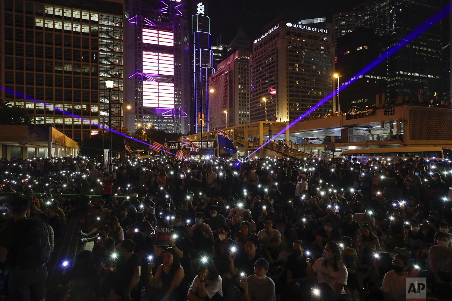Protesters flash their smartphone lights during a rally at Edinburgh Place in Hong Kong, Saturday, Oct. 19, 2019. (AP Photo/Mark Schiefelbein)