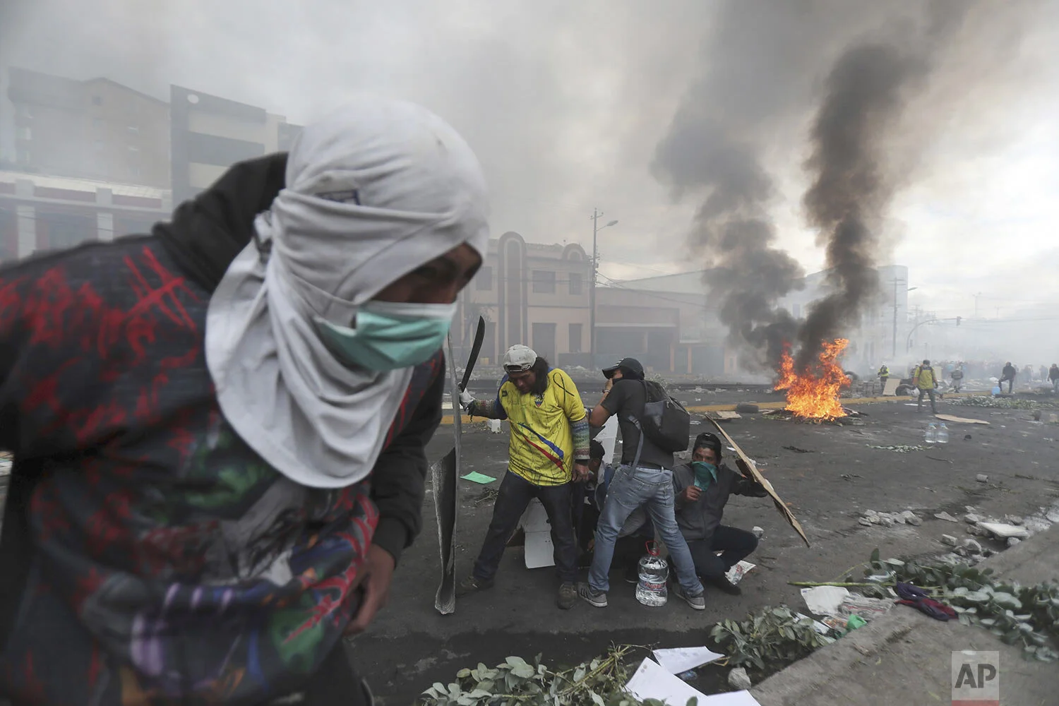 Anti-government demonstrators clash with the police near the national assembly building in Quito, Ecuador, Saturday, Oct. 12, 2019. Indigenous leaders of protests that have paralyzed Ecuador’s economy for nearly a week say they are willing to negotiate with President Lenin Moreno, signaling a possible exit from the crisis, which was triggered by the cancellation of fuel subsidies by Moreno. (AP Photo/Dolores Ochoa)