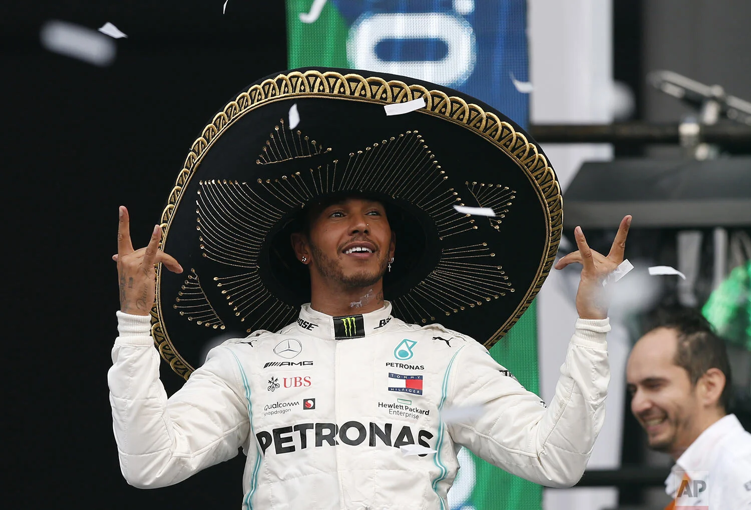 Mercedes driver Lewis Hamilton, of Britain, dons a Mexican Charro hat as he celebrates his victory in the Formula One Mexico Grand Prix auto race at the Hermanos Rodriguez racetrack in Mexico City, Sunday, Oct. 27, 2019. (AP Photo/Rebecca Blackwell)