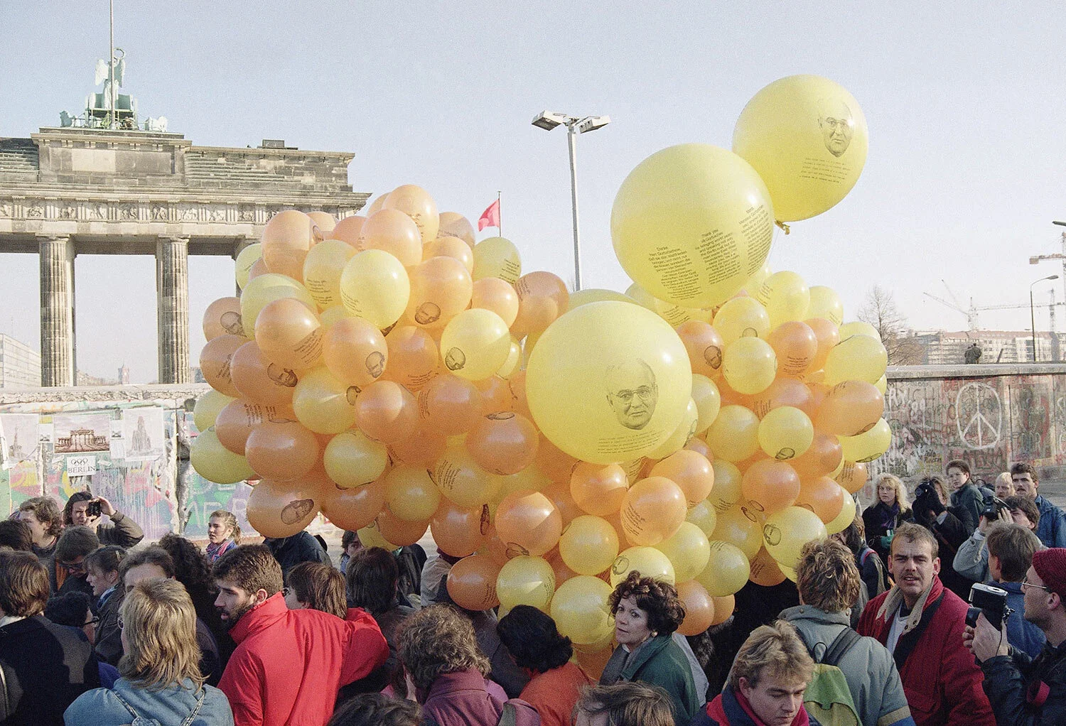 West Berliners release hundreds of balloons with photo of Mikhail S. Gorbachev and a message to the Soviet leader in front of Brandenburg Gate in West Berlin near the wall, Nov. 17, 1989. They wanted to say thank you to Soviet President Mikhail S. Gorbachev for pulling down the wall. (AP Photo/Thomas Kienzle)