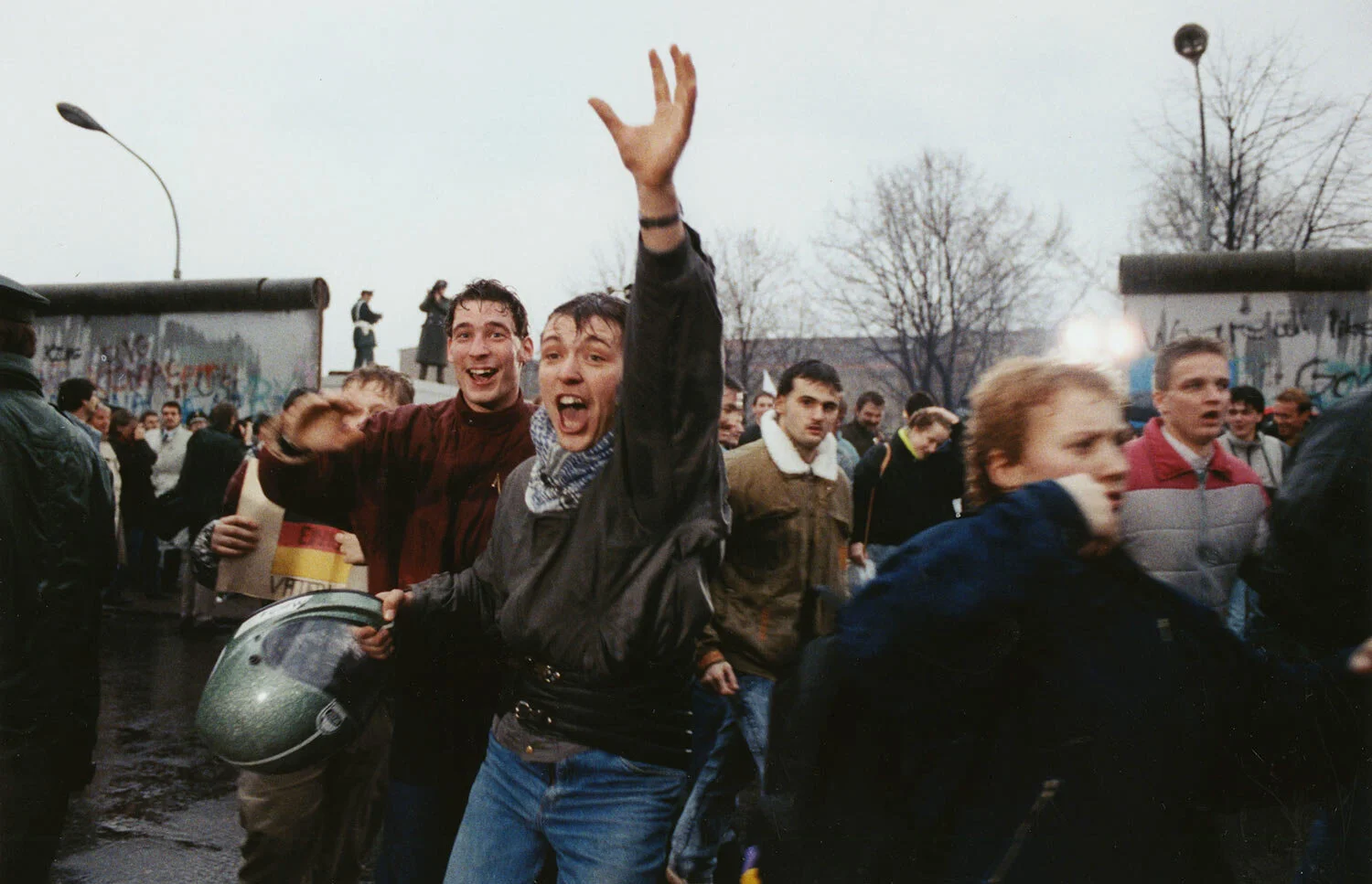 Young East Berliners shout for joy as they run into West Berlin through an opening in the Berlin Wall near the Brandenburg Gate, Fri., Dec. 23, 1989. The new East German government had promised to fully open the gate by Christmas. (AP Photo/Hansjoerg Krauss)