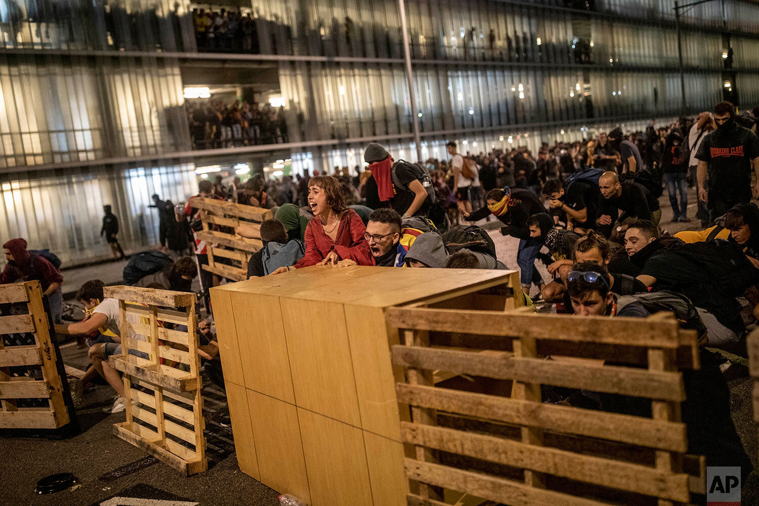  Protesters use makeshift barricades during a demonstration at El Prat airport, outskirts of Barcelona, Spain, Monday, Oct. 14, 2019. Spain's Supreme Court on Monday sentenced 12 prominent former Catalan politicians and activists to lengthly prison t