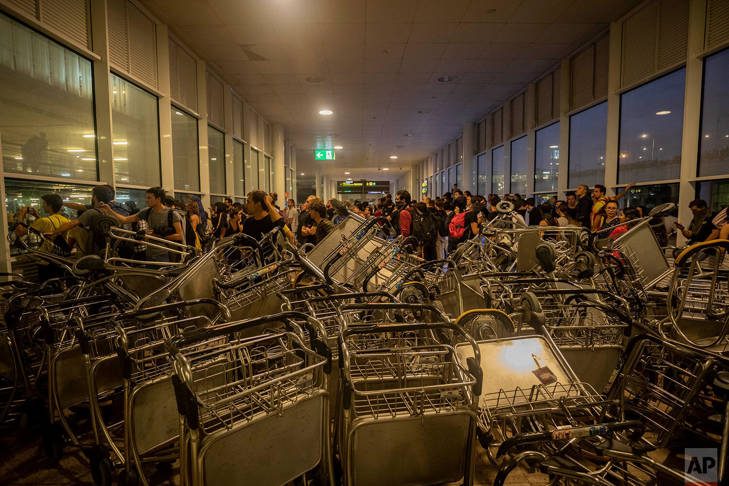  Trolleys block an entrance at El Prat airport, outskirts of Barcelona, Spain, Monday, Oct. 14, 2019. Spain's Supreme Court on Monday sentenced 12 prominent former Catalan politicians and activists to lengthly prison terms for their roles in a 2017 b