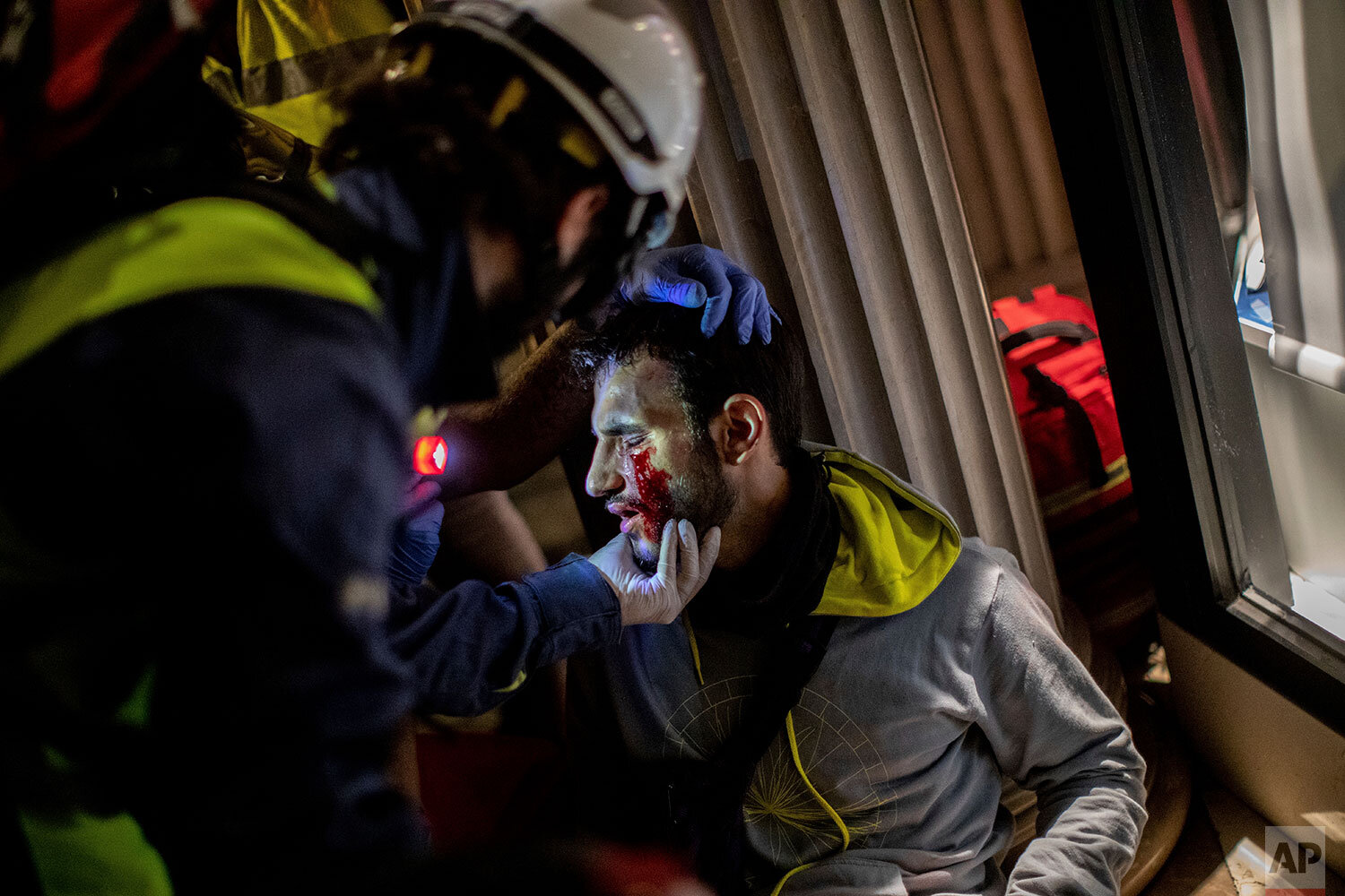  Paramedics attend a protestor during clashes with police in Barcelona, Spain, early Friday, Oct. 18, 2019. Catalonia's separatist leader vowed Thursday to hold a new vote to secede from Spain in less than two years as the embattled northeastern regi