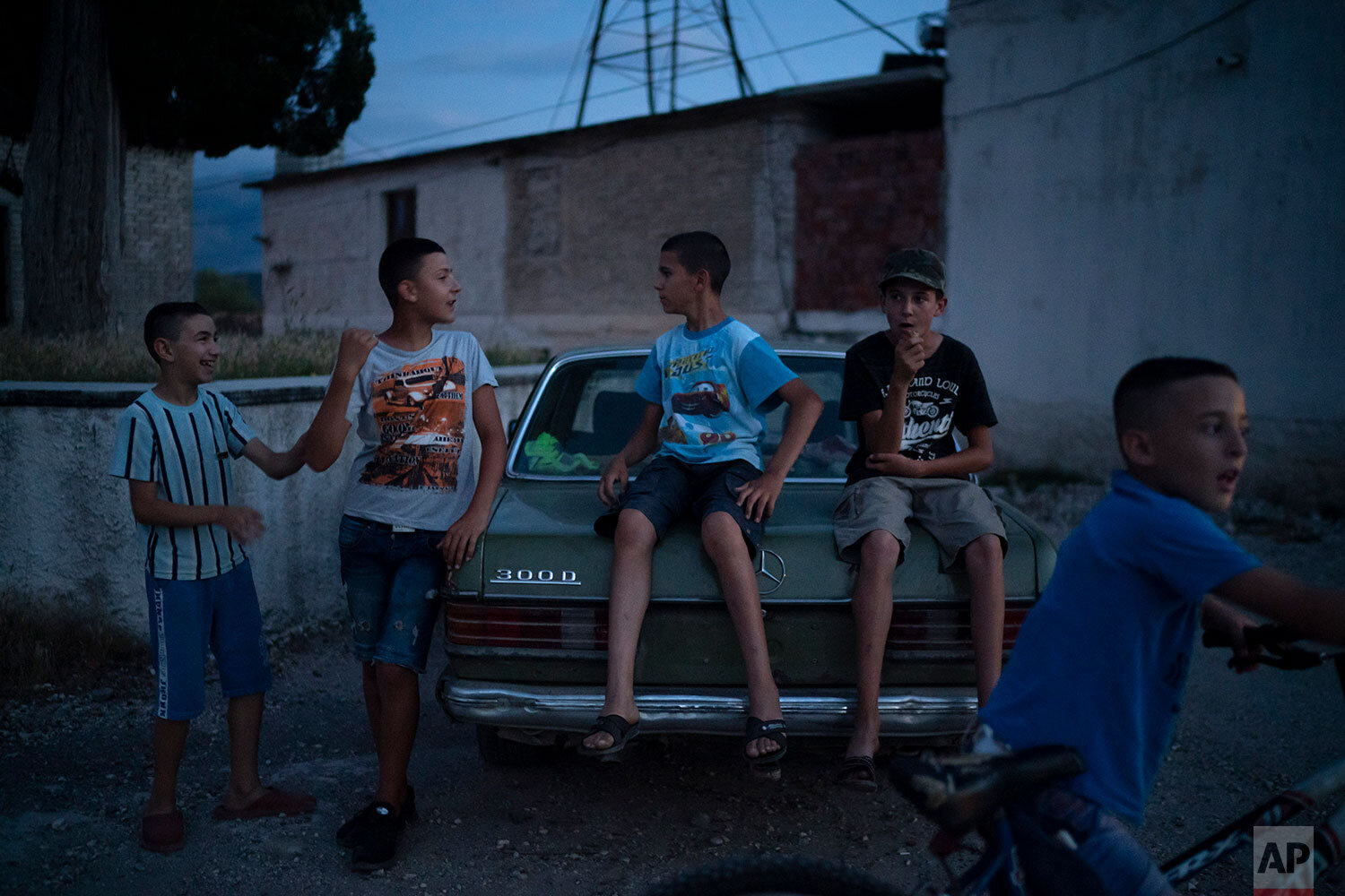  In this June 26, 2019 photo, children play outside at dusk in the village of Kute, Albania. The village overlooks the Vjosa River as it snakes its way north to the sea. Residents here joined a lawsuit against the Pocem dam that would flood their fie