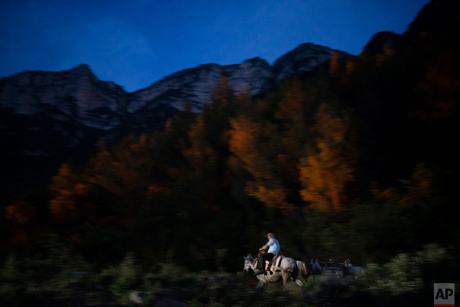  In this June 22, 2019 photo, Jonuz Jonuzi, 70, rides his horse on the banks of the Vjosa River in the Kelcyre Gorge, Albania. He raised his children here and now watches his grandchildren play in the Vjosa's waters. Before dawn each day, he crosses 