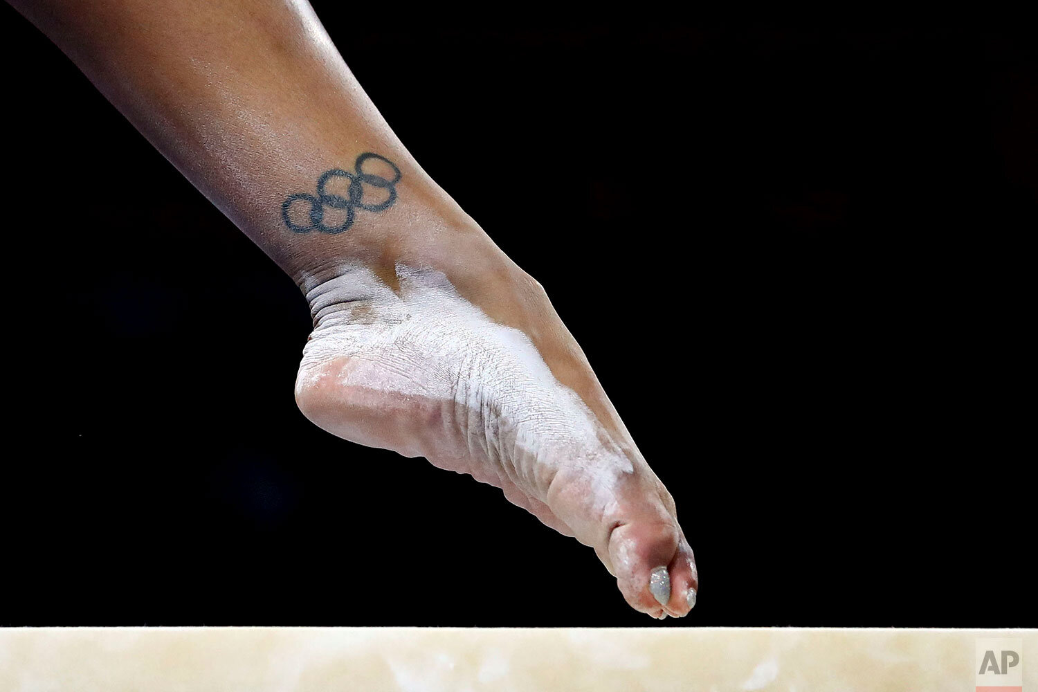  Britain's Rebecca Downie sports a tattoo as she performs on the balance beam during qualifying sessions for the Gymnastics World Championships in Stuttgart, Germany, Saturday, Oct. 5, 2019.(AP Photo/Matthias Schrader) 