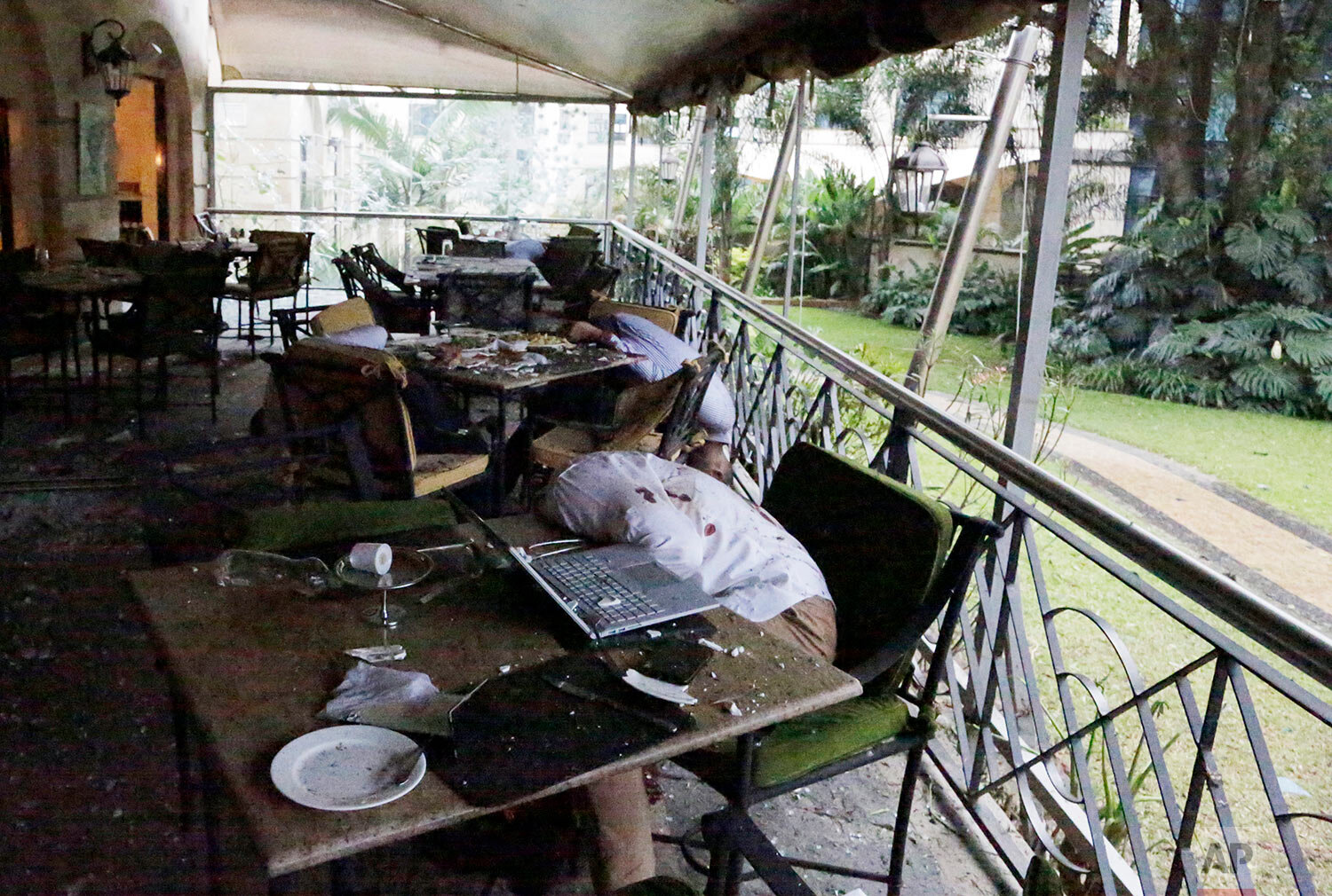  Bodies are slumped in their chairs following a bomb blast at a restaurant in an upscale hotel complex in Nairobi, Kenya, where extremists launched a deadly attack with explosions and heavy gunfire on Jan. 15, 2019. (AP Photo/Khalil Senosi) 