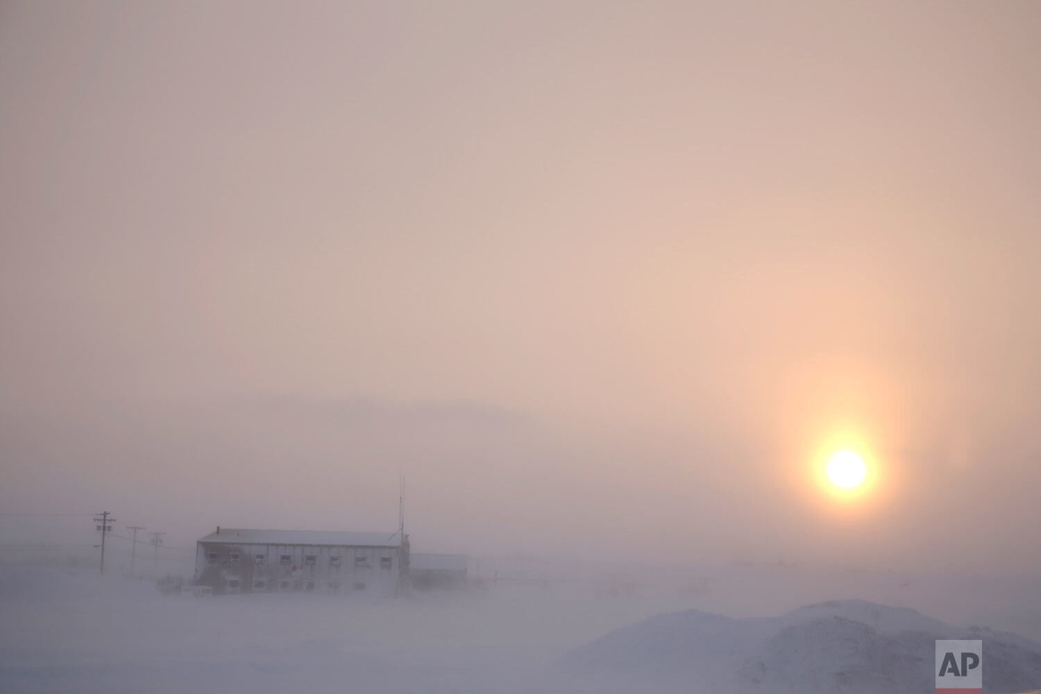  The afternoon sun hangs low as it shines through the snow at the airport in Nome, Alaska, on Feb. 13, 2019. (AP Photo/Wong Maye-E) 