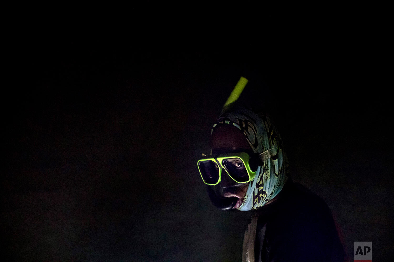  Nicholas Bingham enters the water in Stewart Town, Jamaica, on Feb. 15, 2019, to go night spearfishing, even though the practice is banned, especially in the sanctuaries set up to protect the island's endangered coral reefs and replenish fish stocks