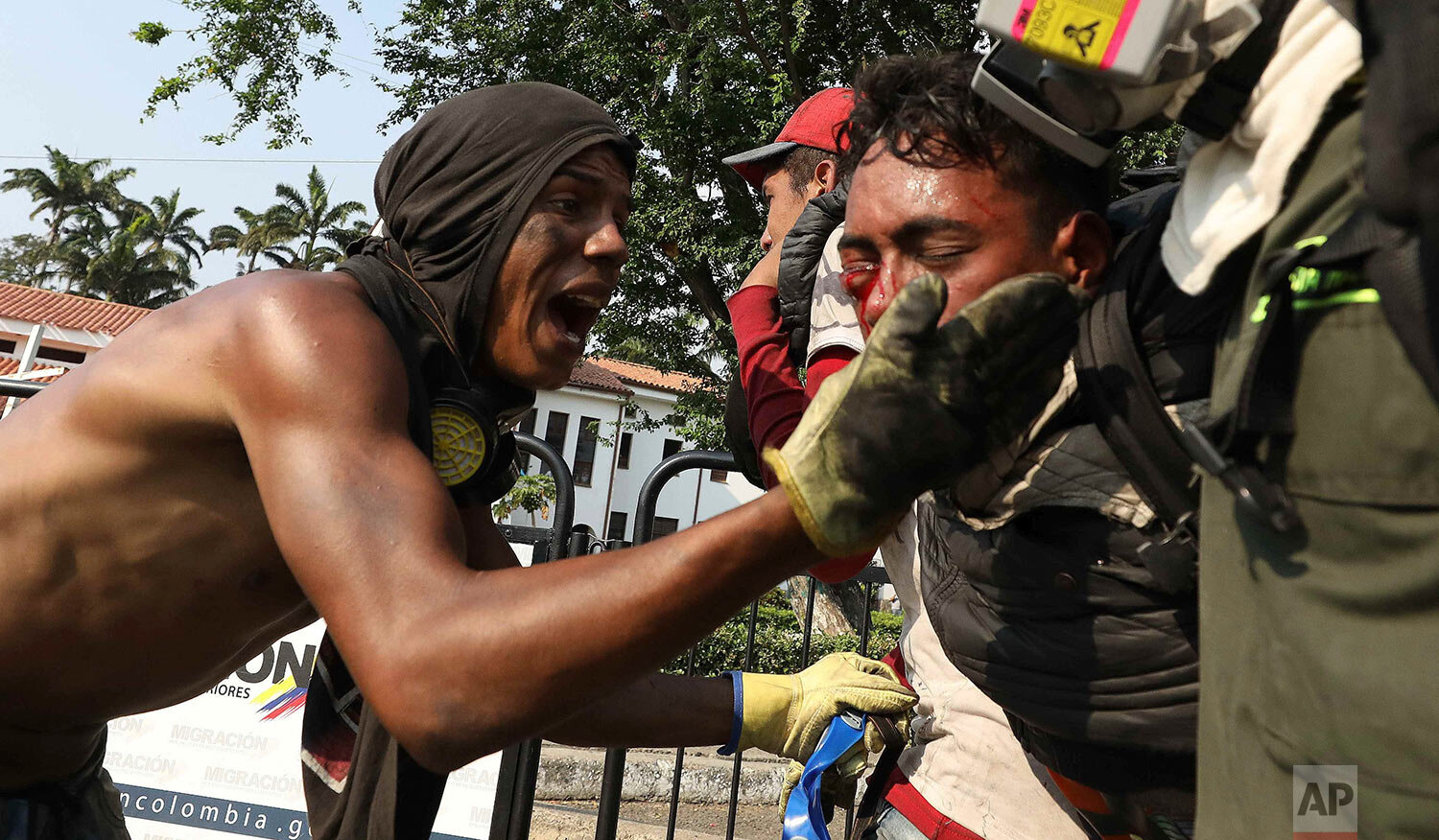  A youth is carried by medics to a safe zone after he was injured in clashes with Venezuelan National Guardsmen blocking the entry of U.S.-supplied humanitarian aid on the Simon Bolivar International Bridge in La Parada, Colombia, near the border wit
