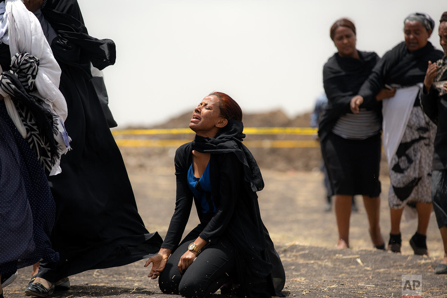  Relatives of crash victims mourn at the scene where the Ethiopian Airlines Boeing 737 Max 8 passenger jet crashed shortly after takeoff, killing all 157 on board, near Bishoftu, Ethiopia, south-east of Addis Ababa, on March 14, 2019. (AP Photo/Mulug