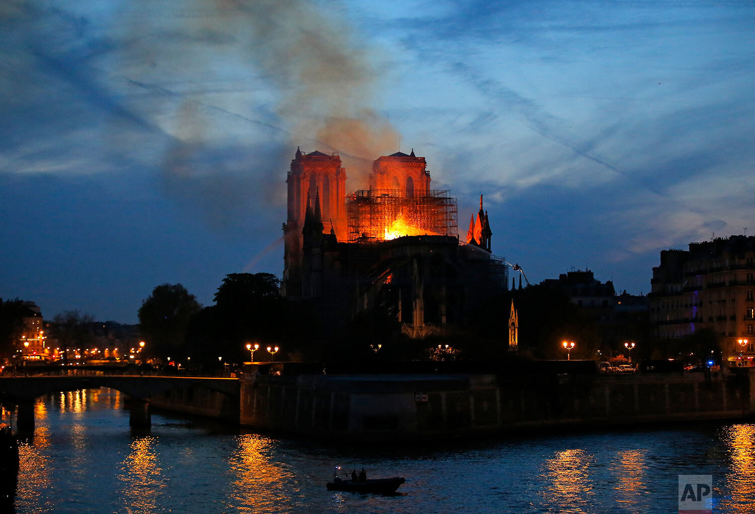  Flames and smoke rise from Notre Dame cathedral in Paris as firefighters tackle the blaze on April 15, 2019. (AP Photo/Michel Euler) 