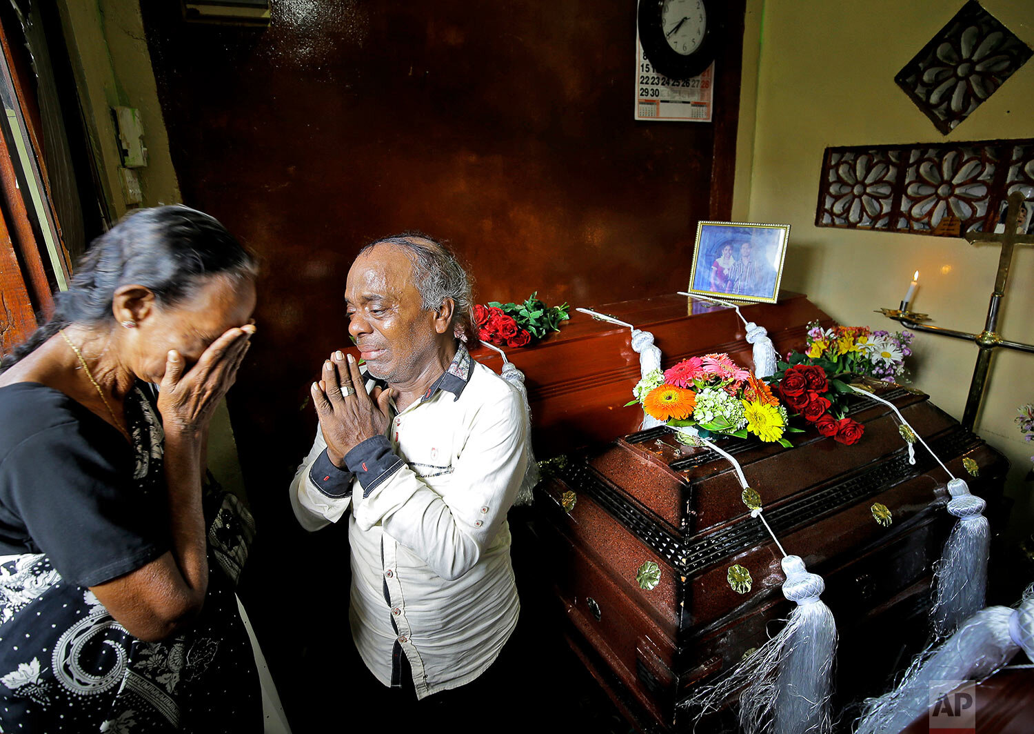  A Sri Lankan family mourns next to the coffins of their three family members, all victims of an Easter Sunday bombing, in Colombo, Sri Lanka, on April 23, 2019. (AP Photo/Eranga Jayawardena) 