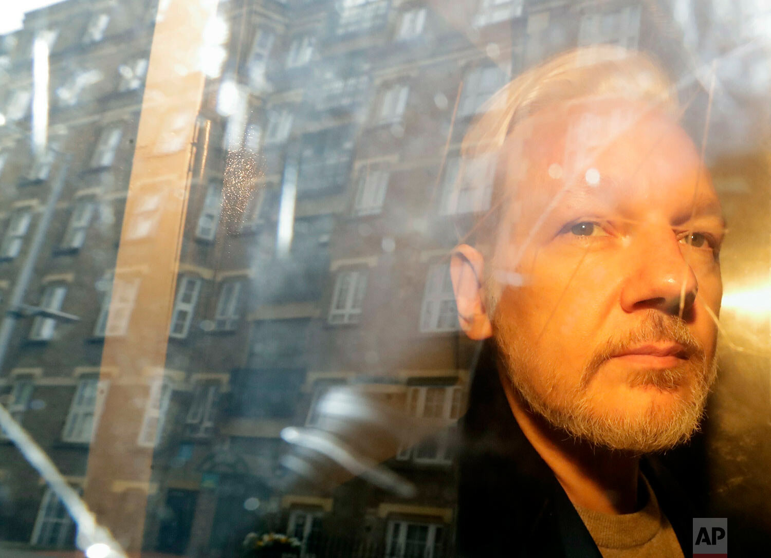  Buildings are reflected in the window of a car as WikiLeaks founder Julian Assange is taken from court, where he appeared on charges of jumping British bail seven years ago, in London on May 1, 2019. (AP Photo/Matt Dunham) 