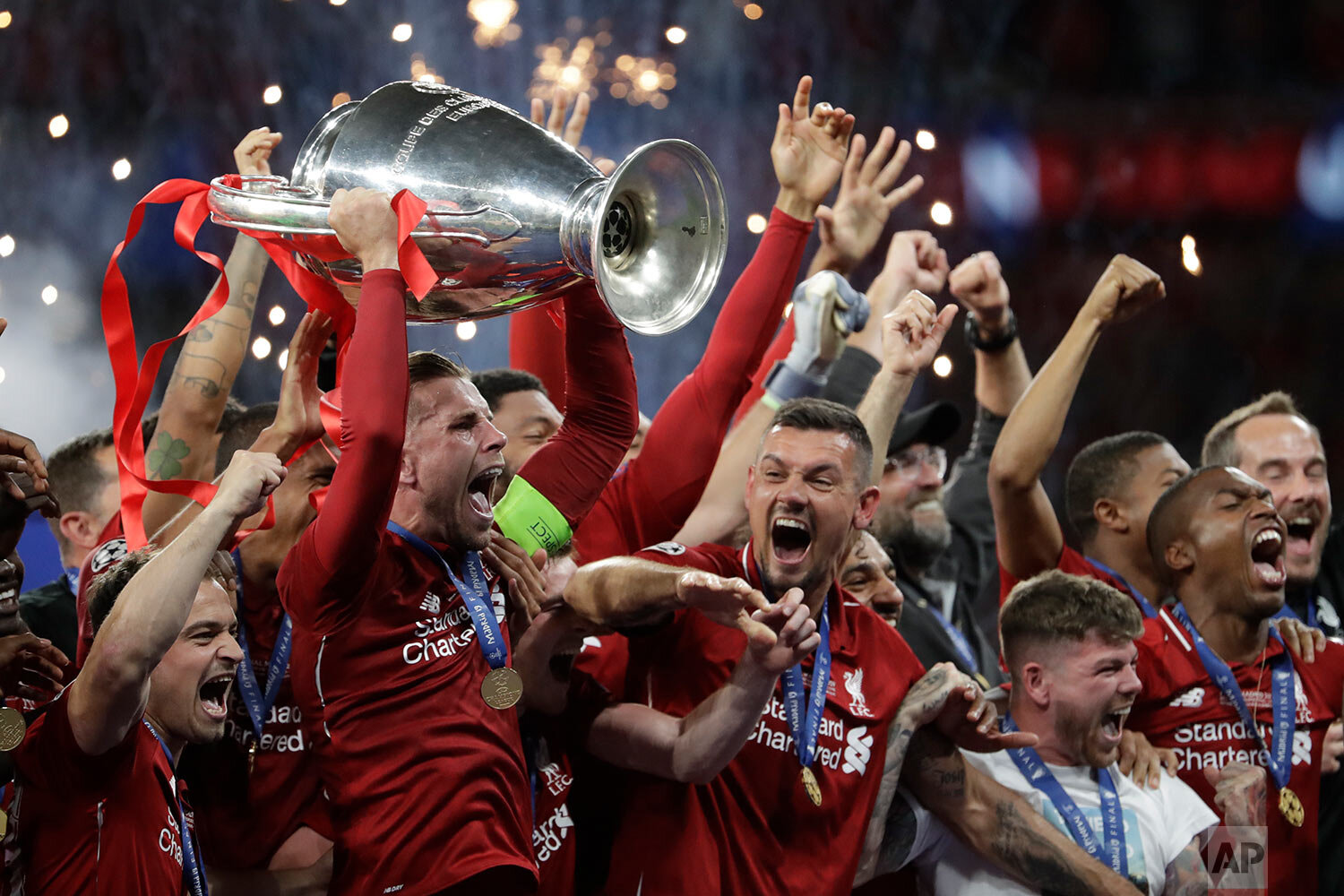  Liverpool's players celebrate with the trophy after winning the Champions League final soccer match between Tottenham Hotspur and Liverpool at the Wanda Metropolitano Stadium in Madrid on June 2, 2019. (AP Photo/Felipe Dana) 