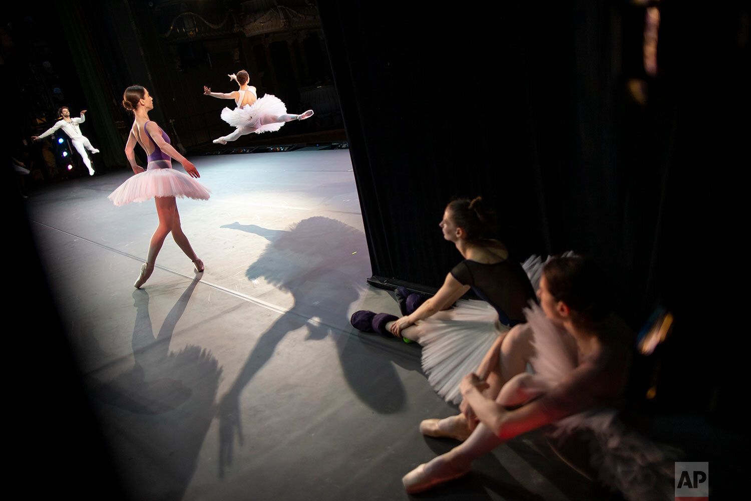  Two ballerinas rest as other dancers perform during a rehearsal in the Bolshoi Theater in Moscow, Russia, on June 11, 2019. (AP Photo/Alexander Zemlianichenko) 