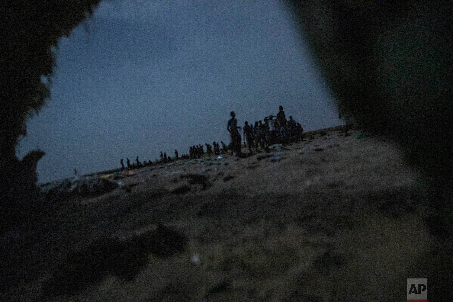  Ethiopian migrants stand in line to board a boat on the uninhabited coast outside the town of Obock, Djibouti, the shore closest to Yemen, on July 15, 2019. (AP Photo/Nariman El-Mofty) 