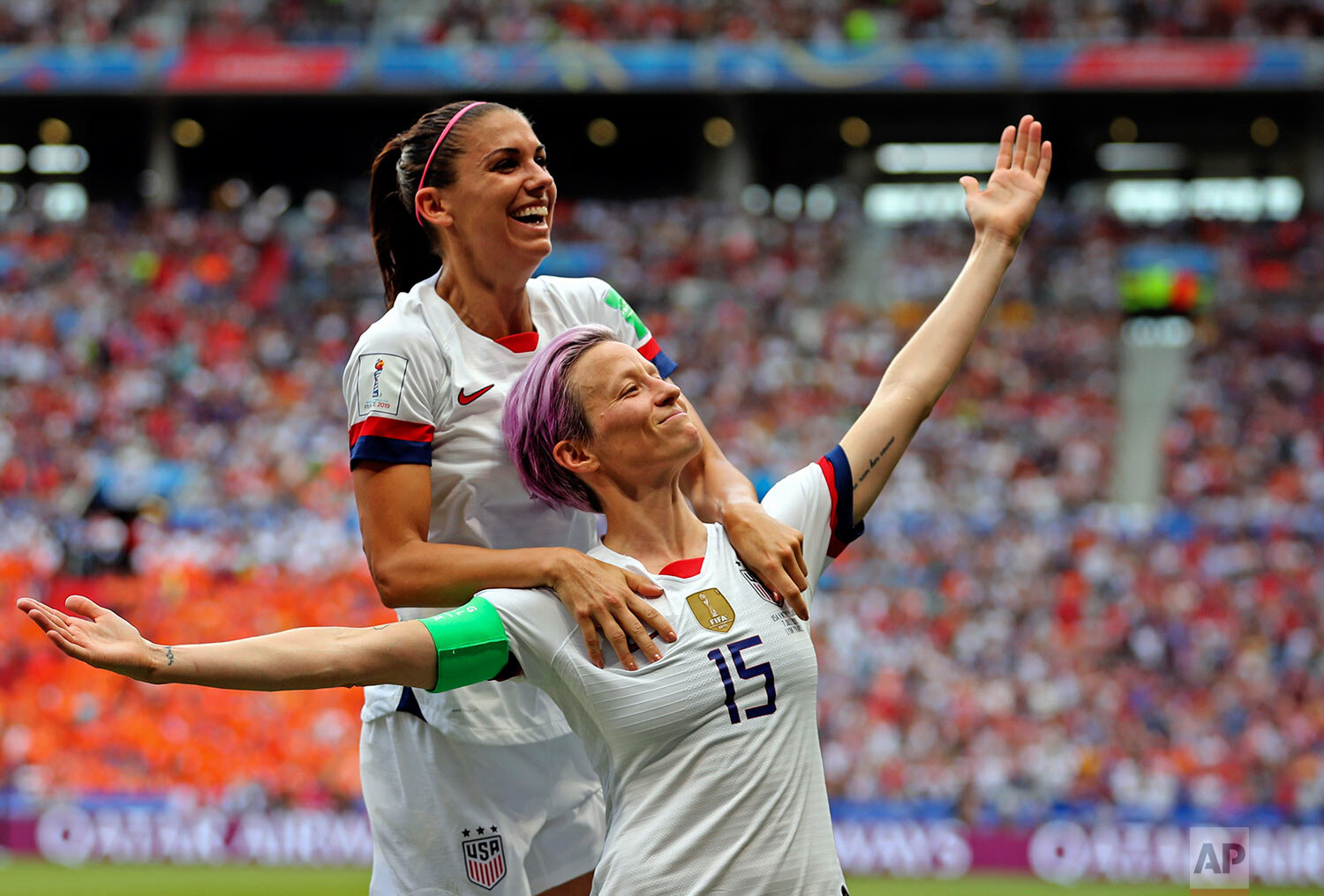  United States' Megan Rapinoe, right, celebrates with Alex Morgan after Rapinoe scored the opening goal from the penalty spot during the Women's World Cup final soccer match between the U.S. and The Netherlands at the Stade de Lyon in Decines, outside Lyon, France, on July 7, 2019. (AP Photo/Francisco Seco) 