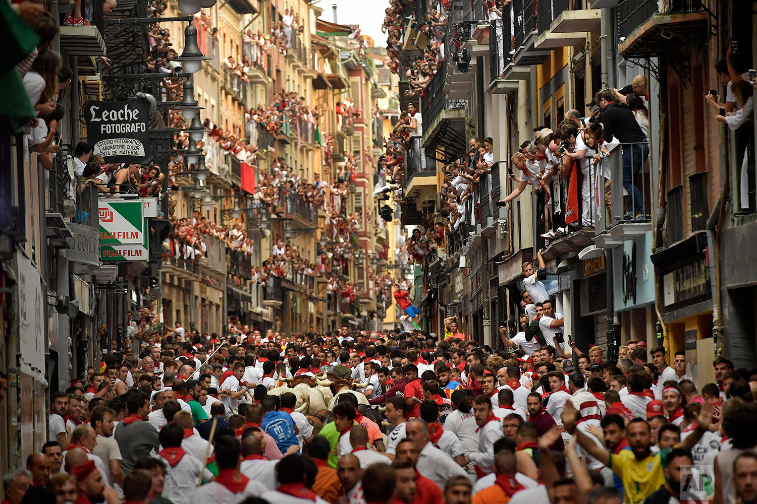  Revellers run next to fighting bulls from Cebada Gago ranch during the running of the bulls at the San Fermin Festival in Pamplona, Spain, on July 8, 2019. (AP Photo/Alvaro Barrientos) 