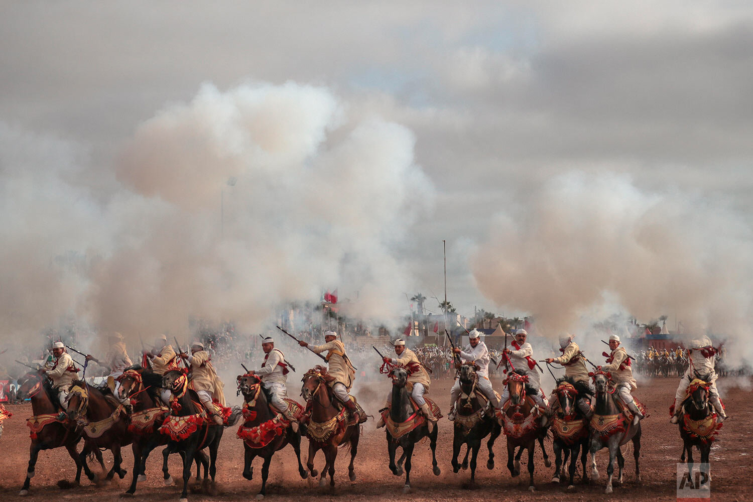  A troupe charges and fires their rifles during Tabourida, a traditional horse riding show also known as Fantasia, in the coastal town of El Jadida, Morocco, on July 25, 2019. (AP Photo/Mosa'ab Elshamy) 