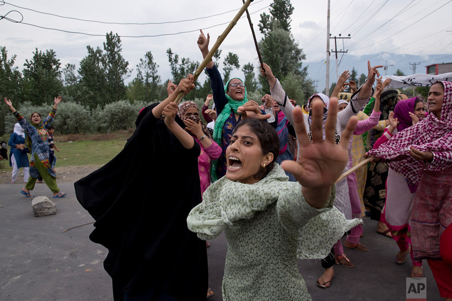  Kashmiri Muslim women shout slogans as Indian policemen fire teargas and live ammunition into the air to stop the protest march in Srinagar, Indian controlled Kashmir, on Aug. 9, 2019. (AP Photo/Dar Yasin) 