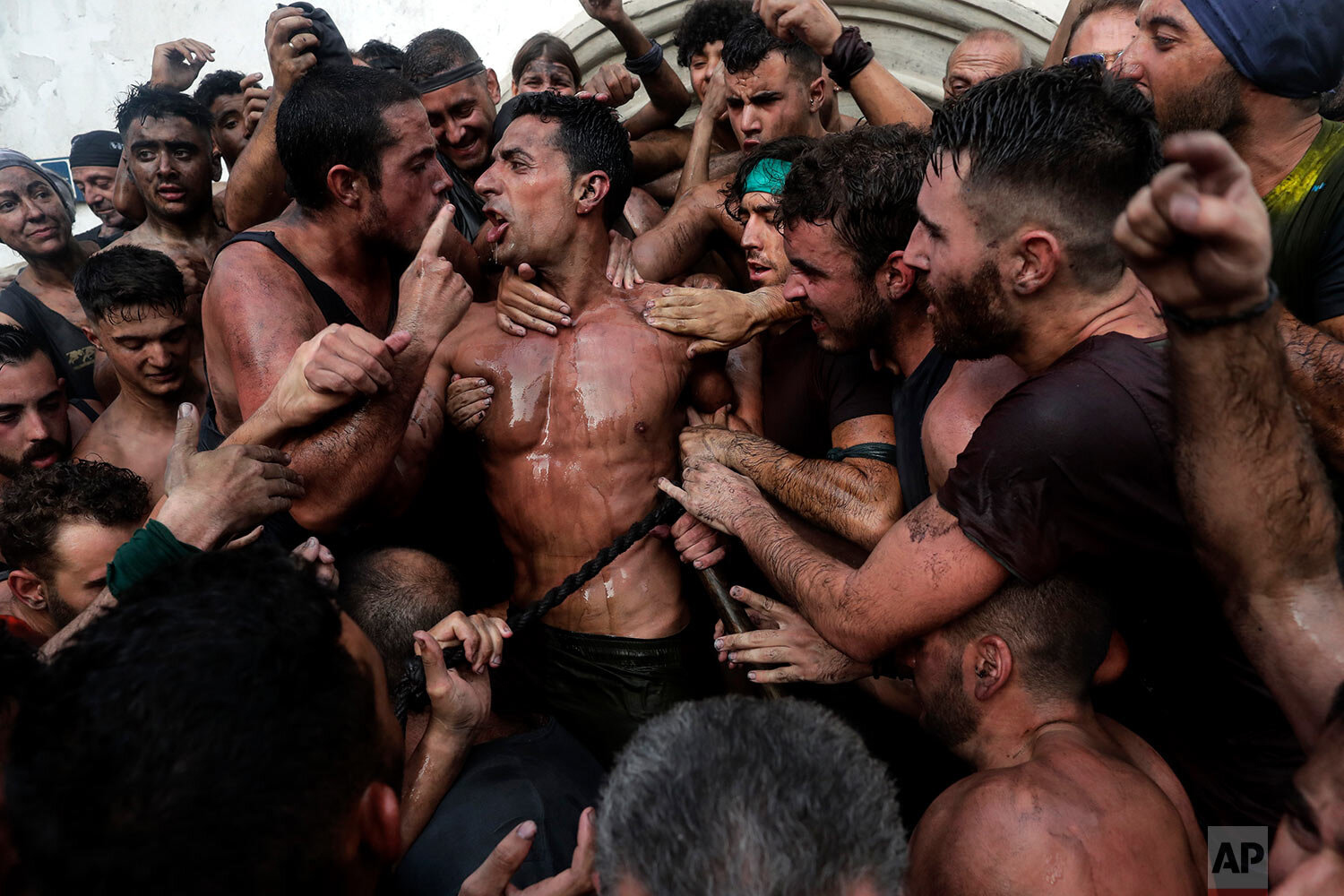  People celebrate during the traditional Cascamorras festival in Baza, Spain, on Sept. 6, 2019. During the festival, and according to an ancient tradition, participants throw black paint over each other for several hours every September 6 in the smal