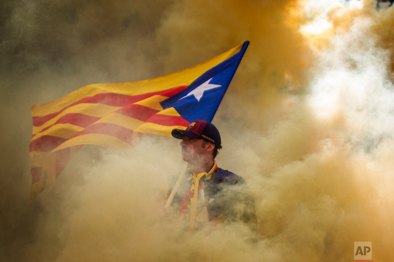  A man holding an independence flag is surrounded by smoke released by demonstrators during the Catalan National Day in Barcelona, Spain, on Sept. 11, 2019. September 11, called "Diada", marks the fall of the Catalan capital to Spanish forces in 1714