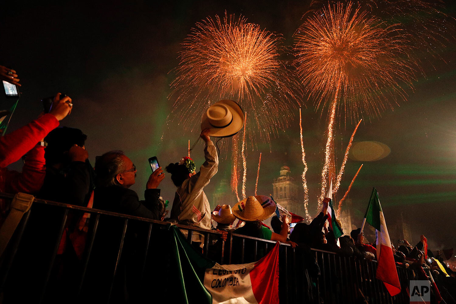  Revelers celebrate as fireworks explode over the Metropolitan Cathedral in Mexico City after President Andres Manuel Lopez Obrador gave the annual independence shout from the balcony of the National Palace to kick off Independence Day celebrations o