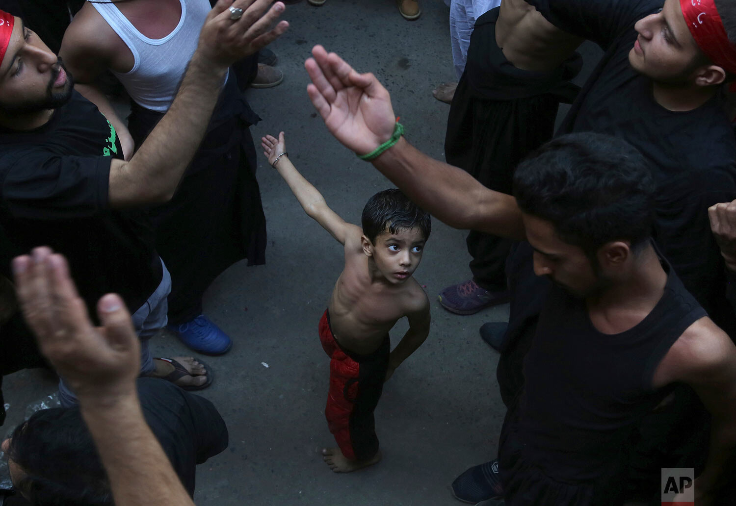  A Shiite Muslim child beats his chest next to his father during a procession to mark the end of the 40-day mourning period following the anniversary of the 7th century death of Imam Hussein, the Prophet Muhammad's grandson and one of Shiite Islam's 