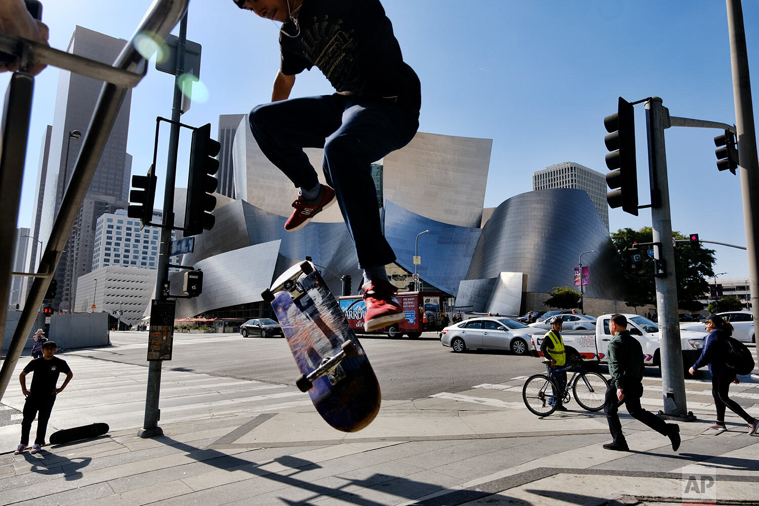  A skateboarder attempts to jump a small staircase across the street from the Walt Disney Concert Hall in downtown Los Angeles on Oct. 29, 2019. (AP Photo/Richard Vogel) 