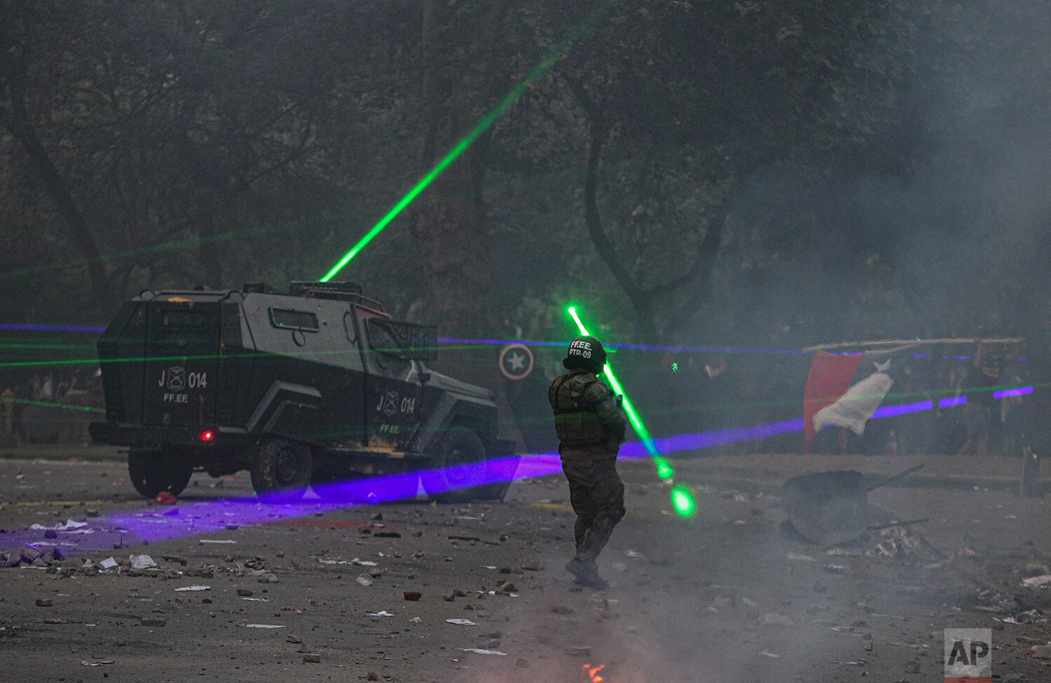  Anti-government demonstrators shine laser pointers at the police during a protest in Santiago, Chile, on Nov. 12, 2019. (AP Photo/Esteban Felix) 