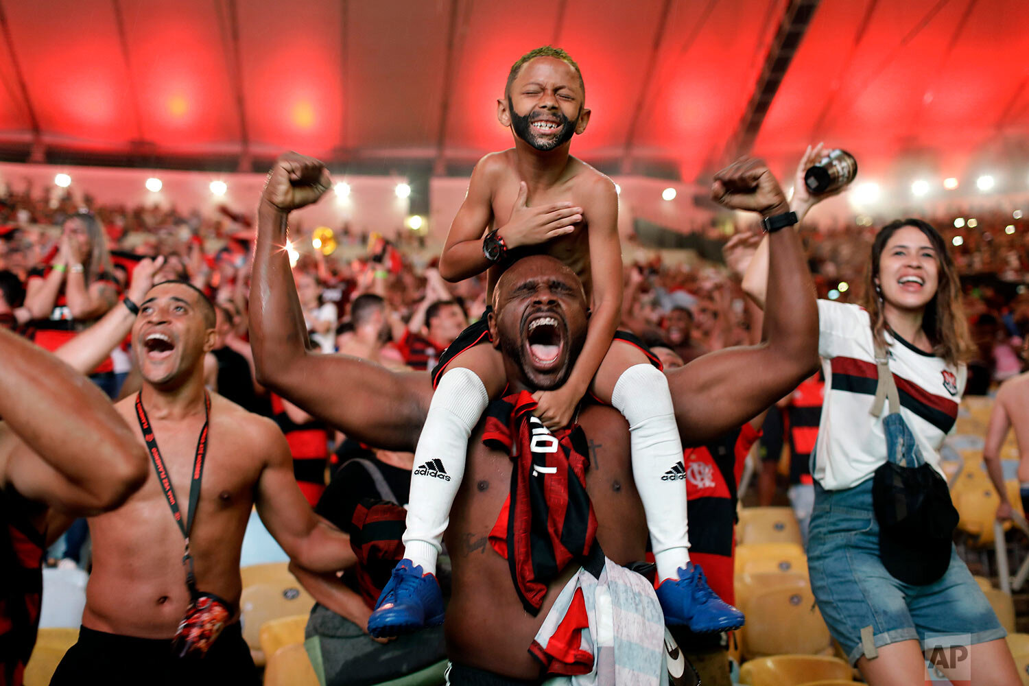  Flamengo soccer fans cheer a goal scored by Gabriel against Argentina's River Plate in the Copa Libertadores final match, broadcast on a giant screen at a watch party at the Maracanã Stadium, in Rio de Janeiro, Brazil, on Nov. 23, 2019. (AP Photo/Si