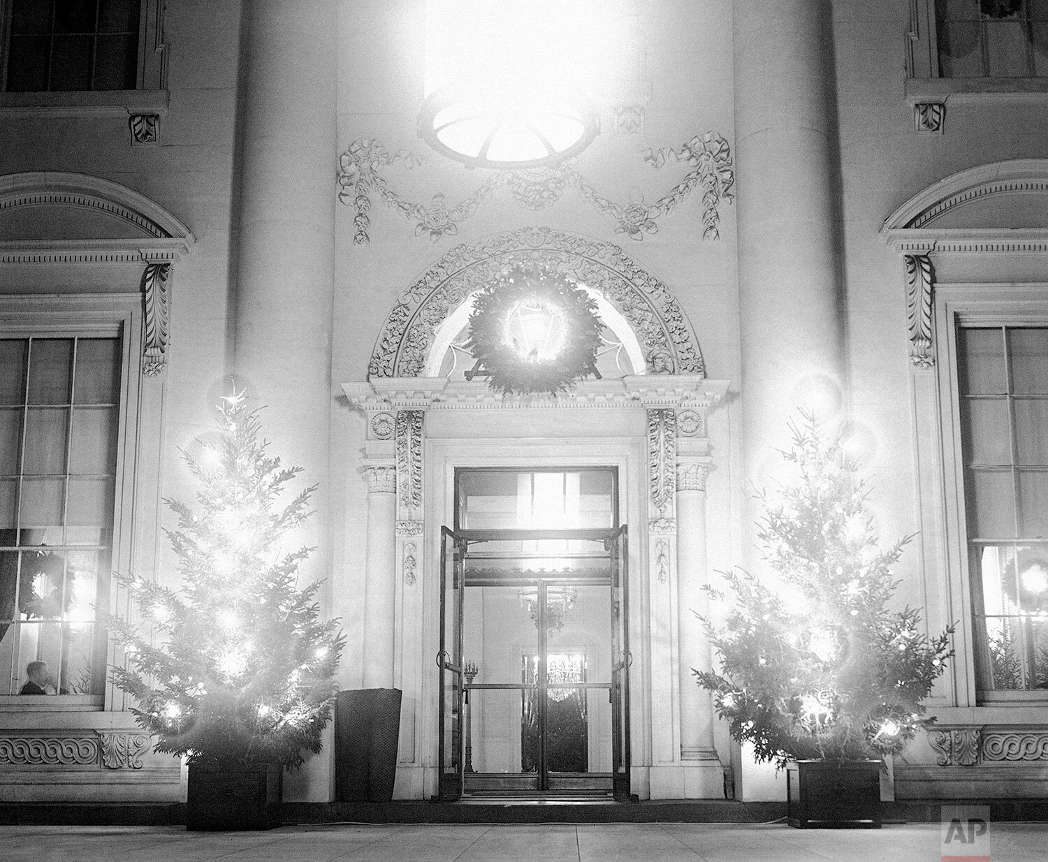  Lighted Christmas trees in front of the portals of the White House in Washington on Dec. 25, 1931. (AP Photo) 
