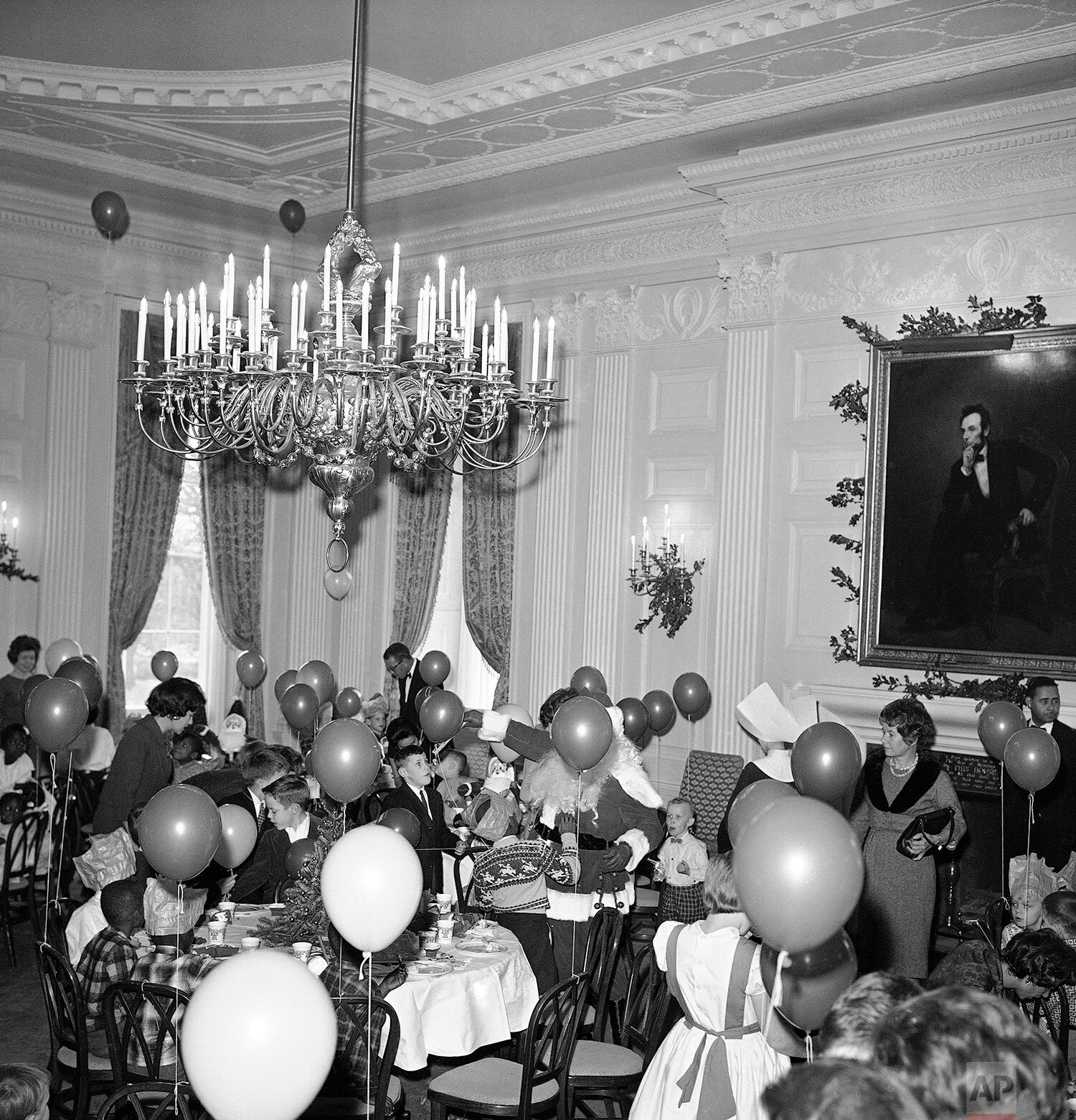  The State Dining Room where the White House holds its formal dinner parties, was jammed with balloon-holding youngsters at a Christmas party for orphans, Dec. 22, 1961.  (AP Photo/Bob Schutz) 