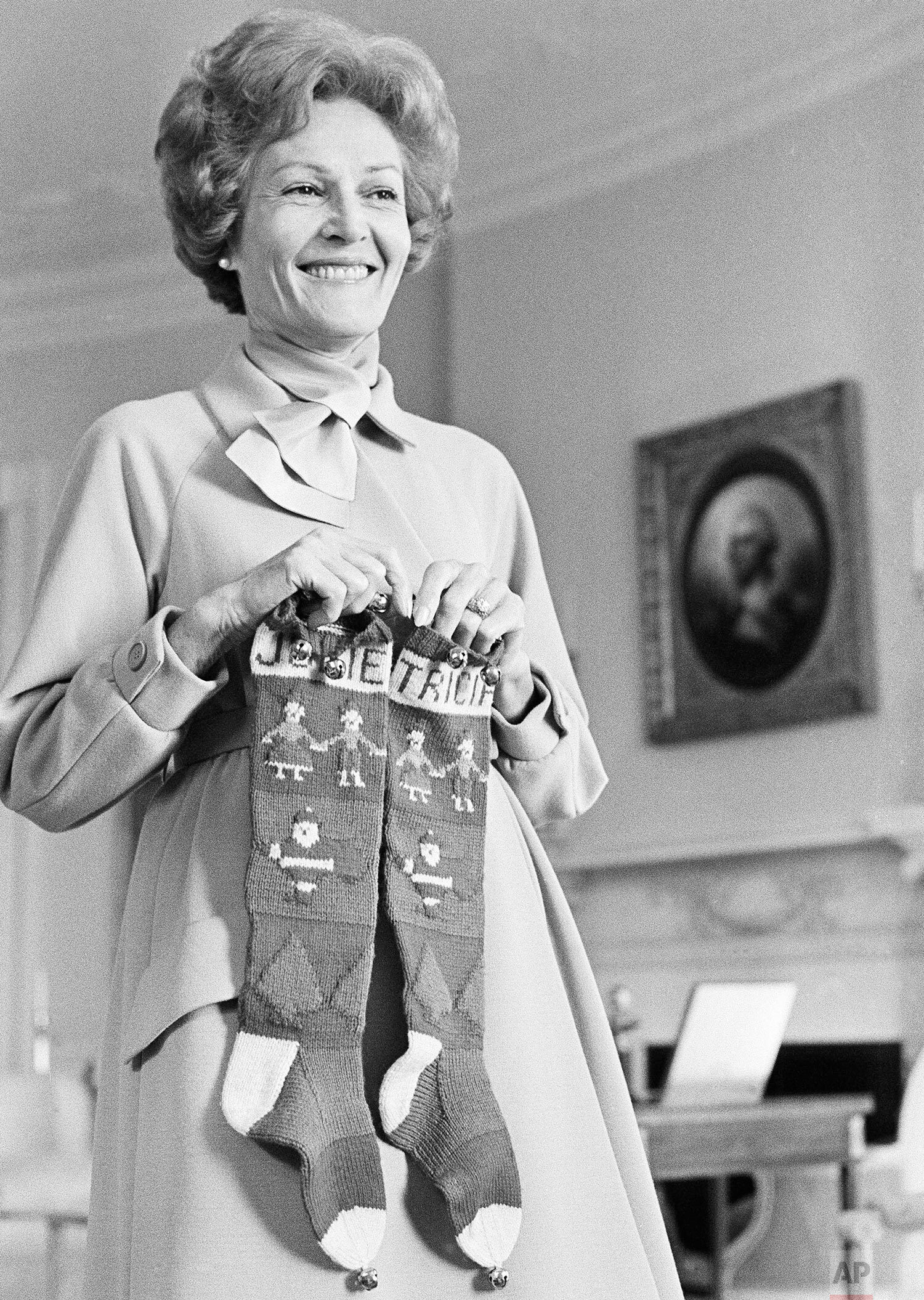  First lady Pat Nixon holds stockings carrying the names of daughters Julie and Tricia as she helps with pre-Christmas decorating at the White House in Washington, Dec. 6, 1969.  (AP Photo/Henry Burroughs) 