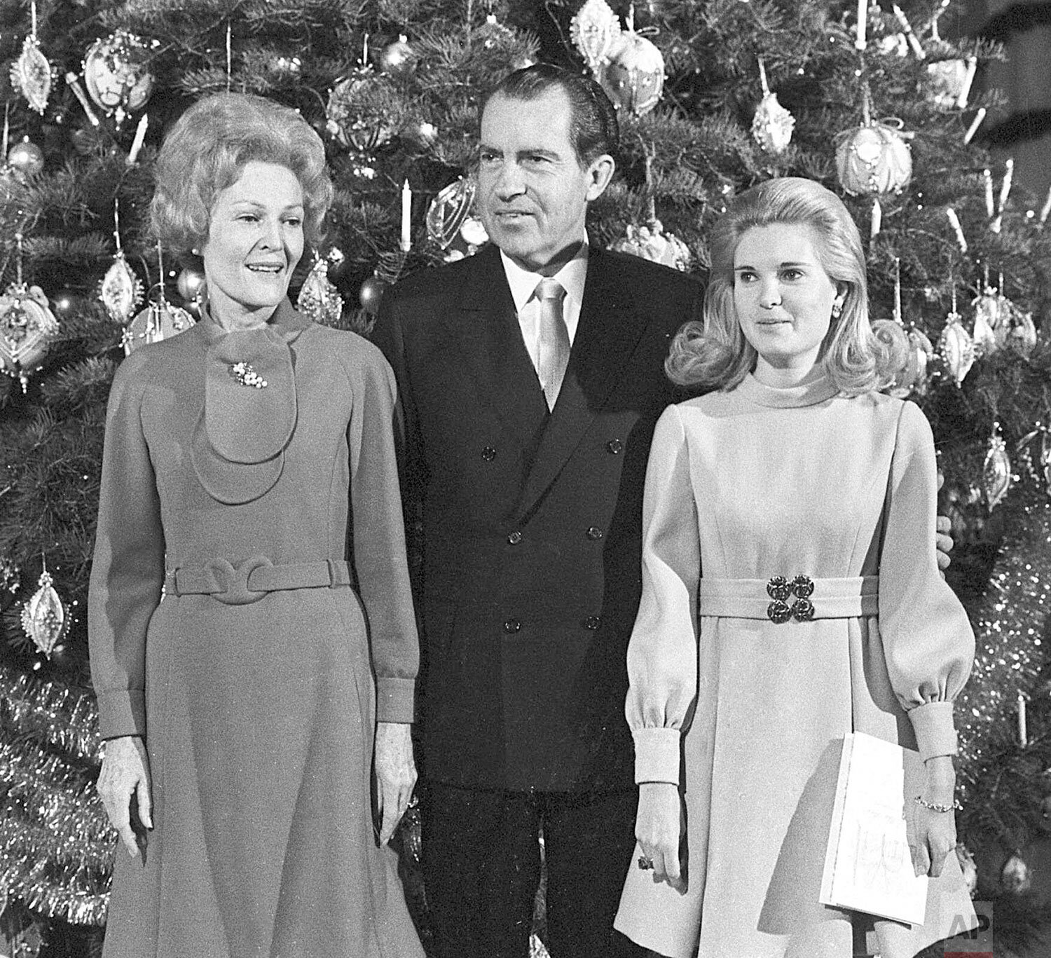  U.S. President Richard Nixon, first lady Pat Nixon and their daughter Tricia stand beside the Christmas tree in the main lobby of the White House on Dec. 21, 1969, following a worship service. (AP Photo) 