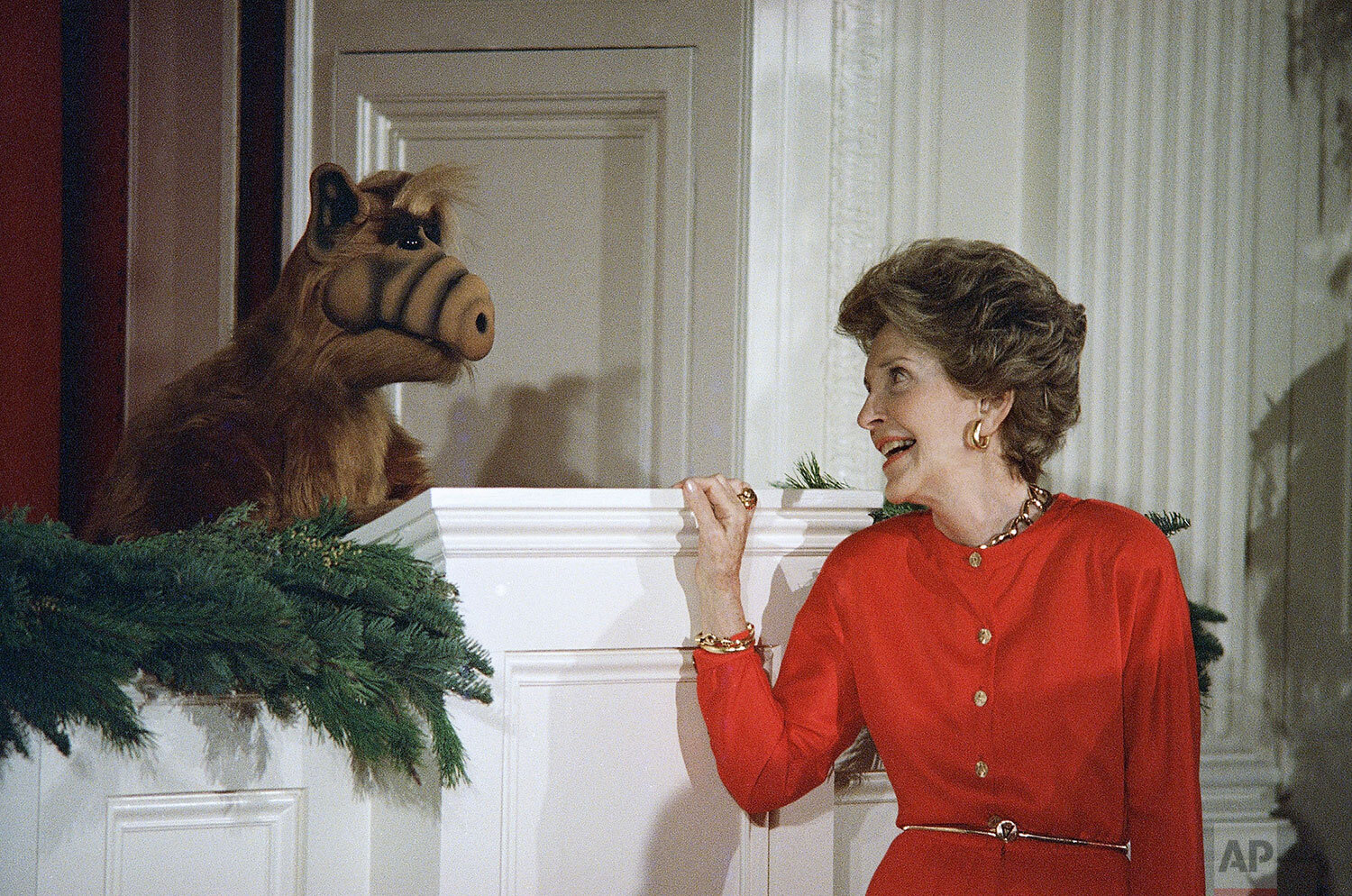  First lady Nancy Reagan glances towards ALF, an alien life form, during a Christmas party for Children of Washington's diplomatic corp at the White House Monday, Dec. 14, 1987. (AP Photo) 