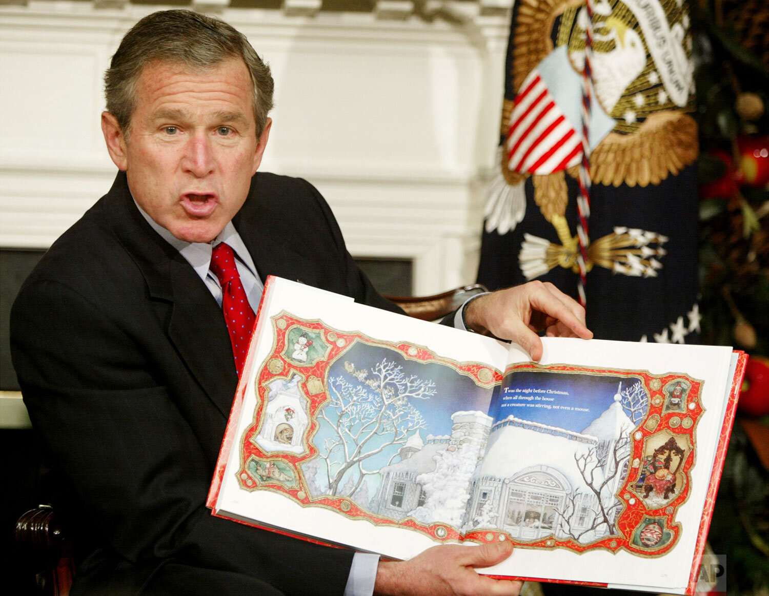  President Bush begins to read to area children as he participates in the White House children's story hour, Tuesday, Dec. 17, 2002, in the Roosevelt Room of the White House in Washington. (AP Photo/Ron Edmonds) 