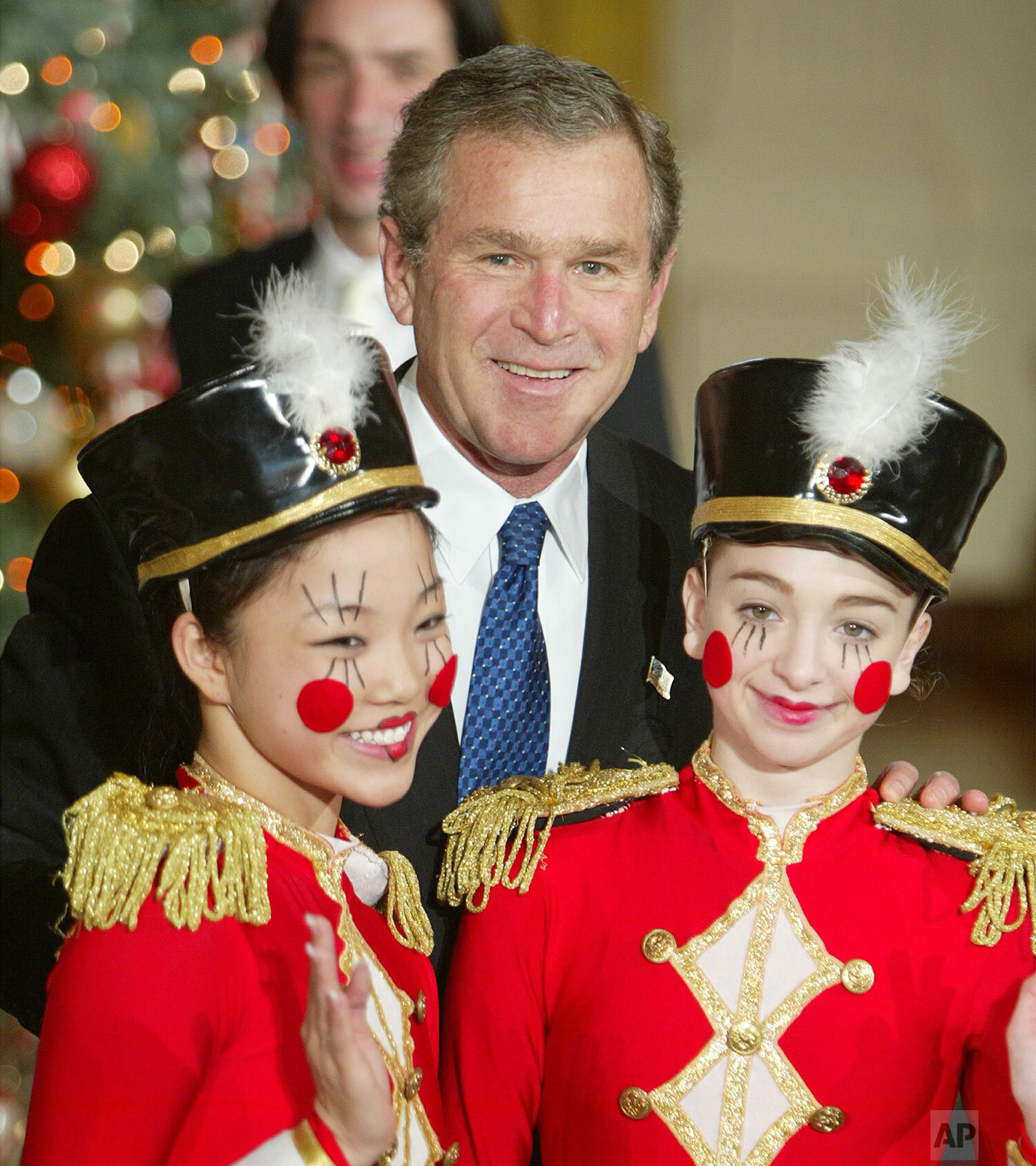  President Bush poses with unidentified members of the Washington Ballet that performed in a children's Christmas reception program Monday, Dec. 8, 2003, at the White House in Washington for local children of military families. (AP Photo/Ron Edmonds)