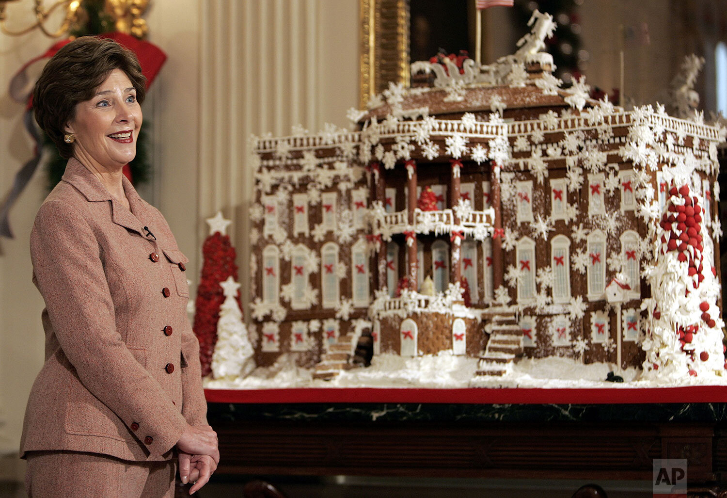  First lady Laura Bush shows of a ginger bread White House while hosting a media preview of the 2006 holiday decorations at the White House in Washington, Thursday, Nov. 30, 2006. (AP Photo/Ron Edmonds) 