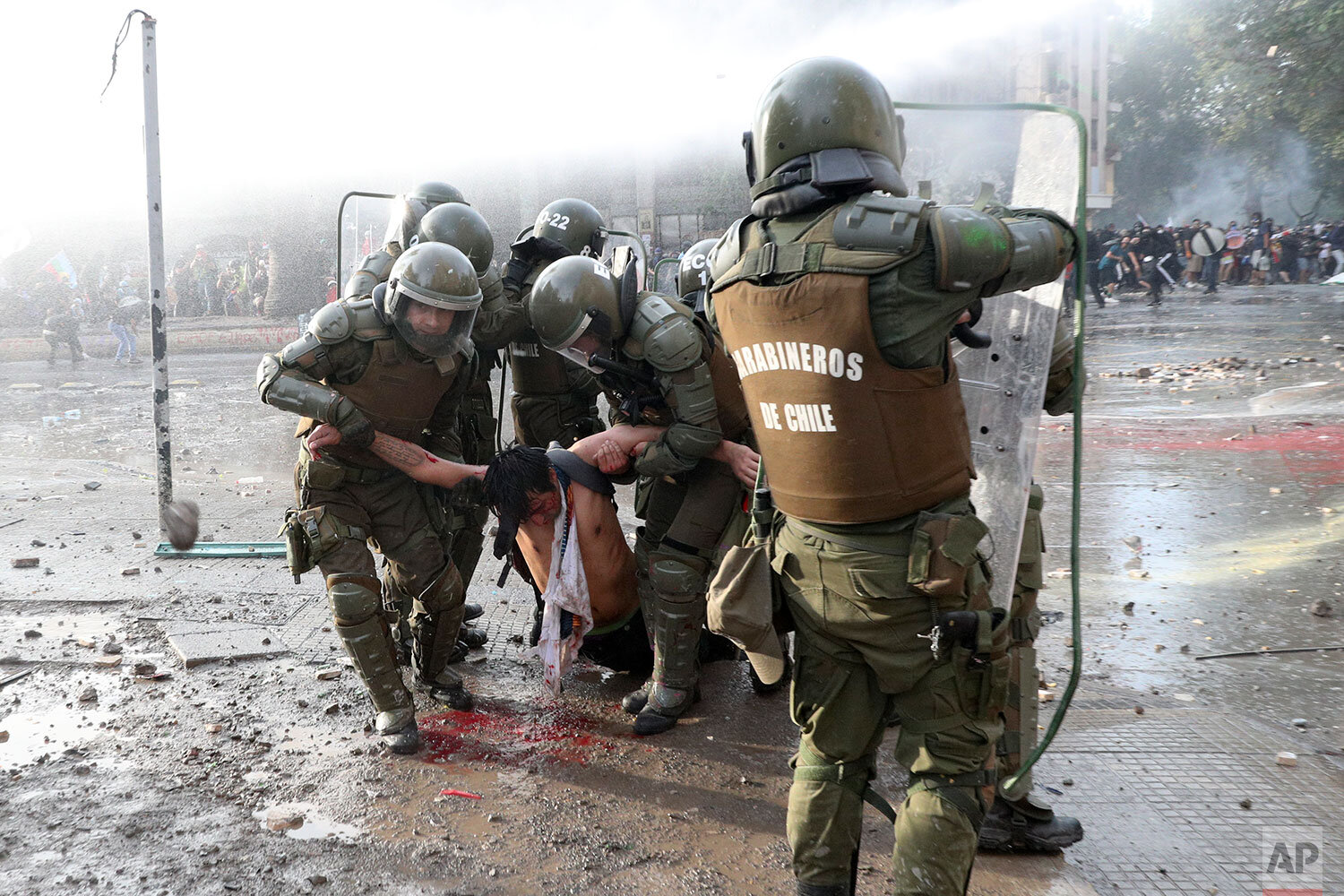  Police carry an anti-government protester injured during clashes in Santiago, Chile, Thursday, Nov. 14, 2019. Students in Chile began protesting nearly a month ago over a subway fare hike. The demonstrations have morphed into a massive protest movem