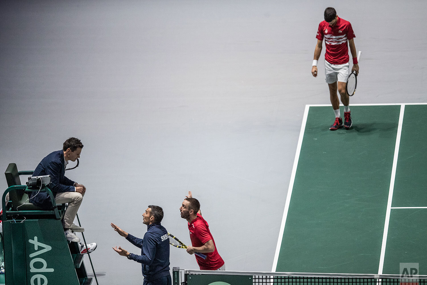  Serbia's captain Nenad Zimonjic and teammate Viktor Troicki, center, argue with the referee during the Davis Cup quarterfinal doubles match against  Russia¥s Karen Khachanov and Andrey Rublev in Madrid, Spain, Friday, Nov. 22, 2019. (AP Photo/Bernat