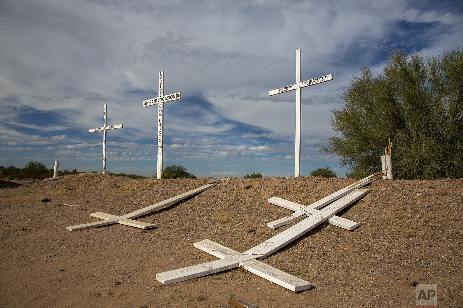  In this Nov. 2, 2019 photo, a memorial for dead migrants lies partially destroyed along the road between Altar and Sasabe, Sonora state, Mexico. (AP Photo/Moises Castillo) 