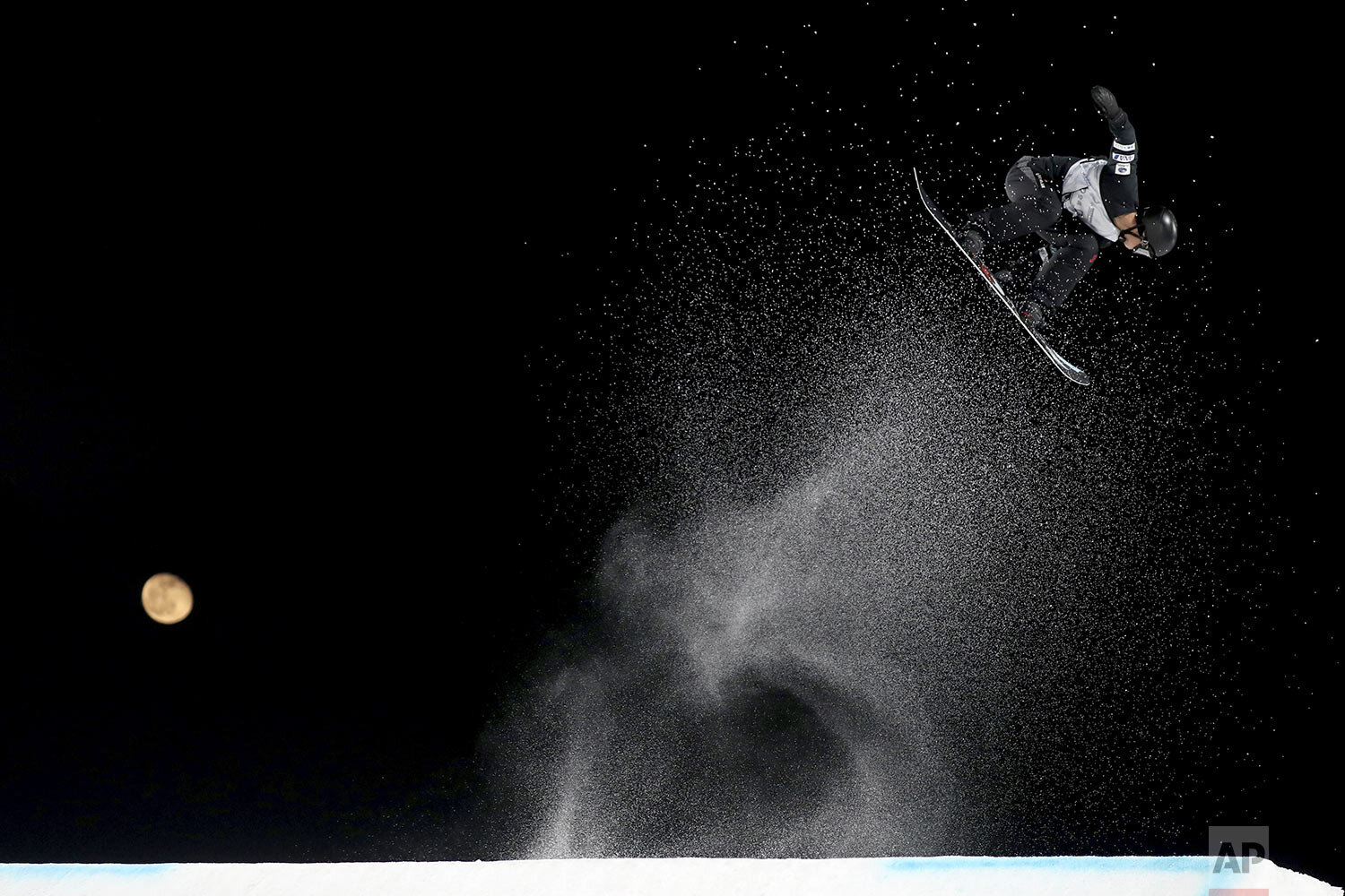  Japan's Ruki Tobita jumps, backdropped by the moon, during the Men's Snowboard Big Air in the 2019 FIS Big Air World Cup held at the Big Air Shougang in Beijing on Saturday, Dec. 14, 2019. (AP Photo/Ng Han Guan) 