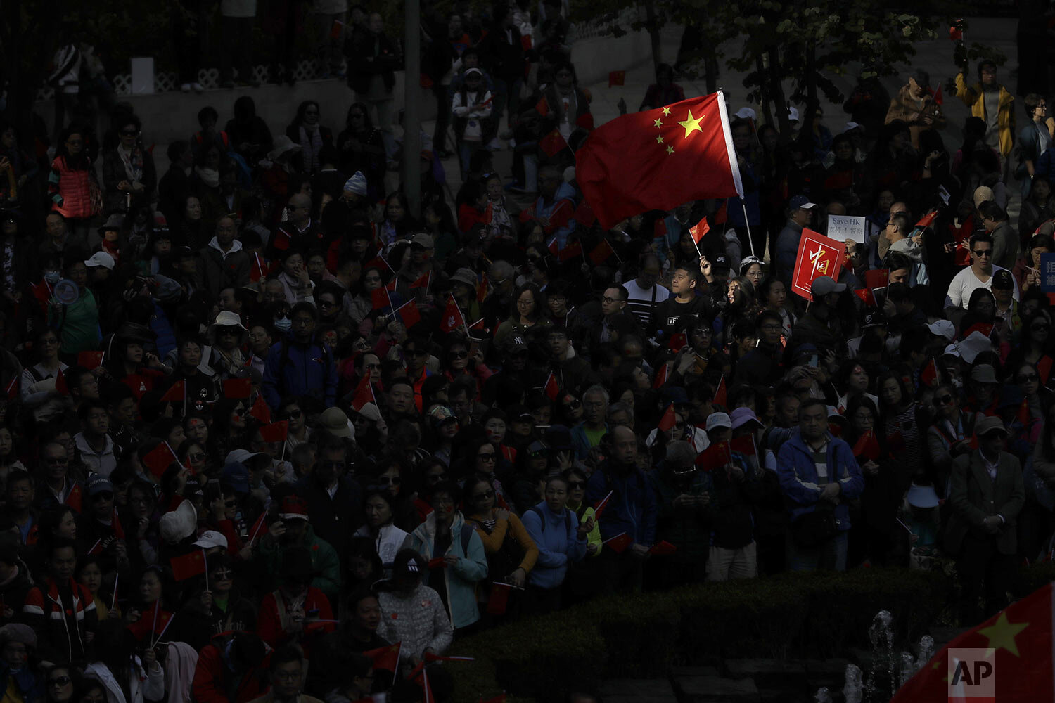  Pro-Beijing supporters wave the Chinese national flags during a rally in Hong Kong on Saturday, Dec. 7, 2019. (AP Photo/Mark Schiefelbein) 