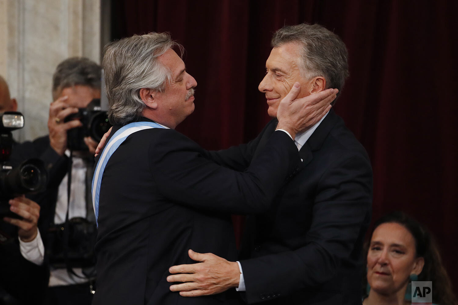  Argentina's new President Alberto Fernandez, left, embraces outgoing president Mauricio Macri after taking the oath of office at Congress in Buenos Aires, Argentina, Dec. 10, 2019. (AP Photo/Natacha Pisarenko) 