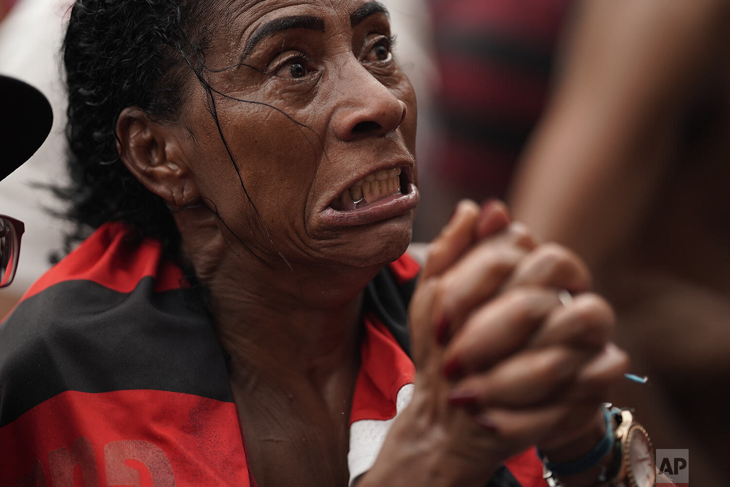  A fan of Brazil's Flamengo soccer team reacts after England's Liverpool scored a goal against her team as she watches a live broadcast of the FIFA Club World Cup final soccer match, in the Rocinha slum in Rio de Janeiro, Brazil, Dec. 21, 2019. (AP P